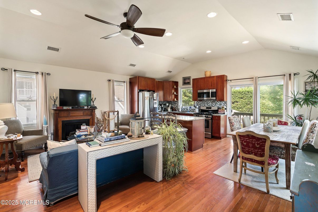 Dining room, Fireplace, Interior, Kitchen, Living room, Recessed Lighting, Stainless Steel Appliances, Wood Texture Flooring
