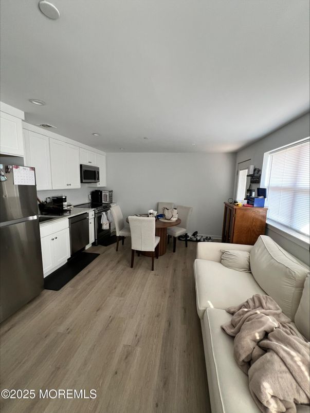 Dining room, Interior, Kitchen, Living room, Recessed Lighting, Stainless Steel Appliances, Wood Texture Flooring