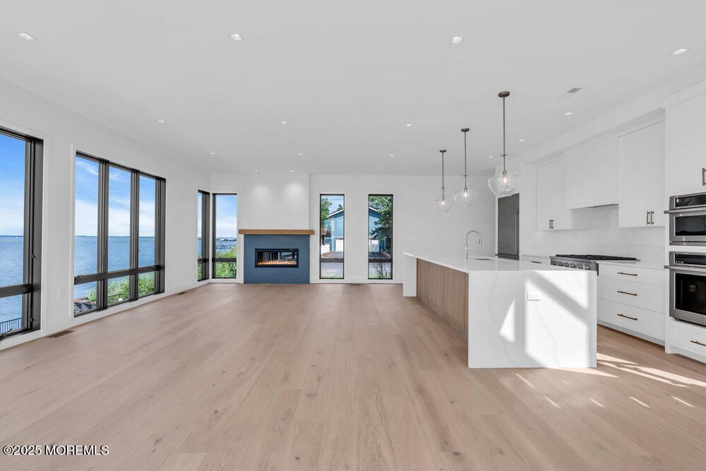 Fireplace, Interior, Kitchen, Pendant Lights, Recessed Lighting, Stainless Steel Appliances, Water, Wood Texture Flooring