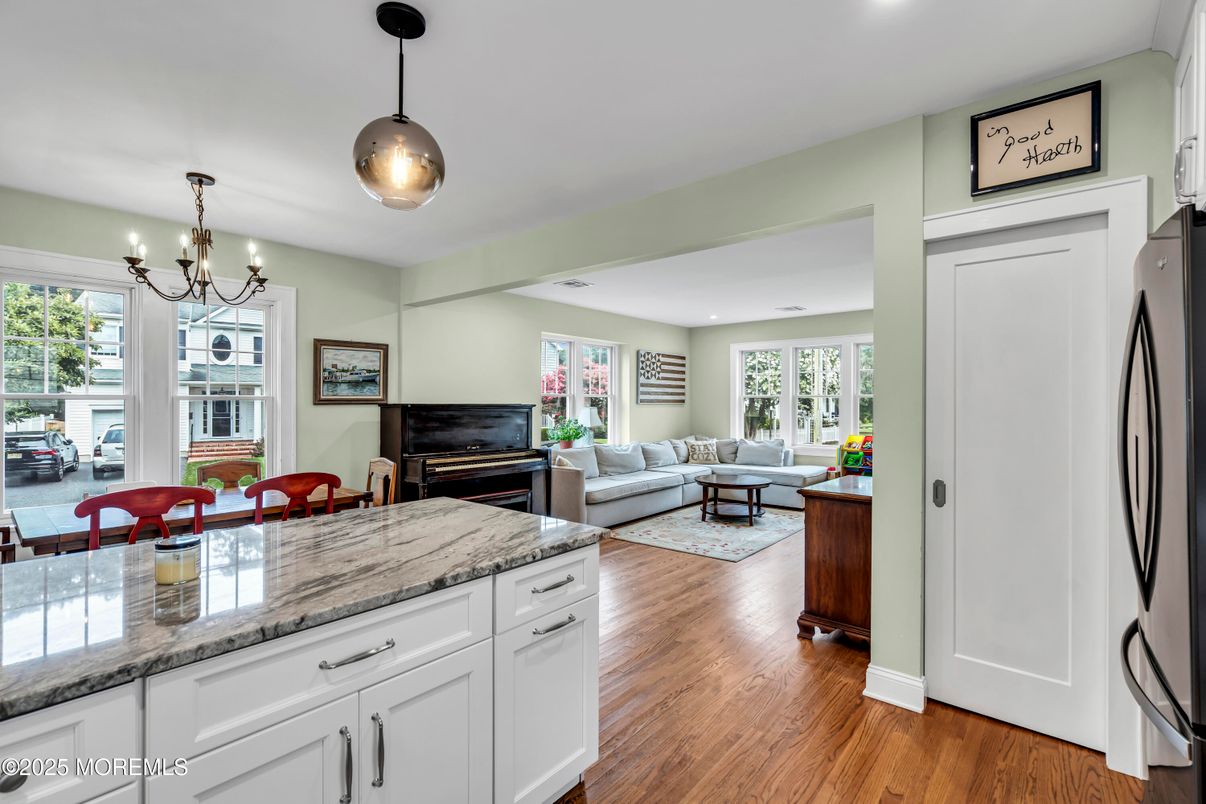 Chandelier, Dining room, Fireplace, Interior, Living room, Pendant Lights, Recessed Lighting, Wood Texture Flooring