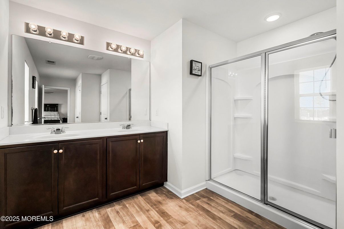 Bathroom, Dual Sink Vanities, Glass Shower, Interior, Recessed Lighting, Wood Texture Flooring
