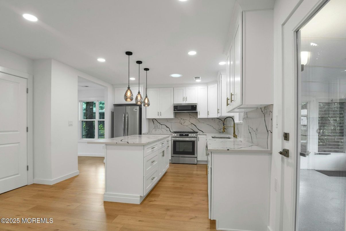 Interior, Kitchen, Marble Walls, Pendant Lights, Recessed Lighting, Stainless Steel Appliances, Wood Texture Flooring