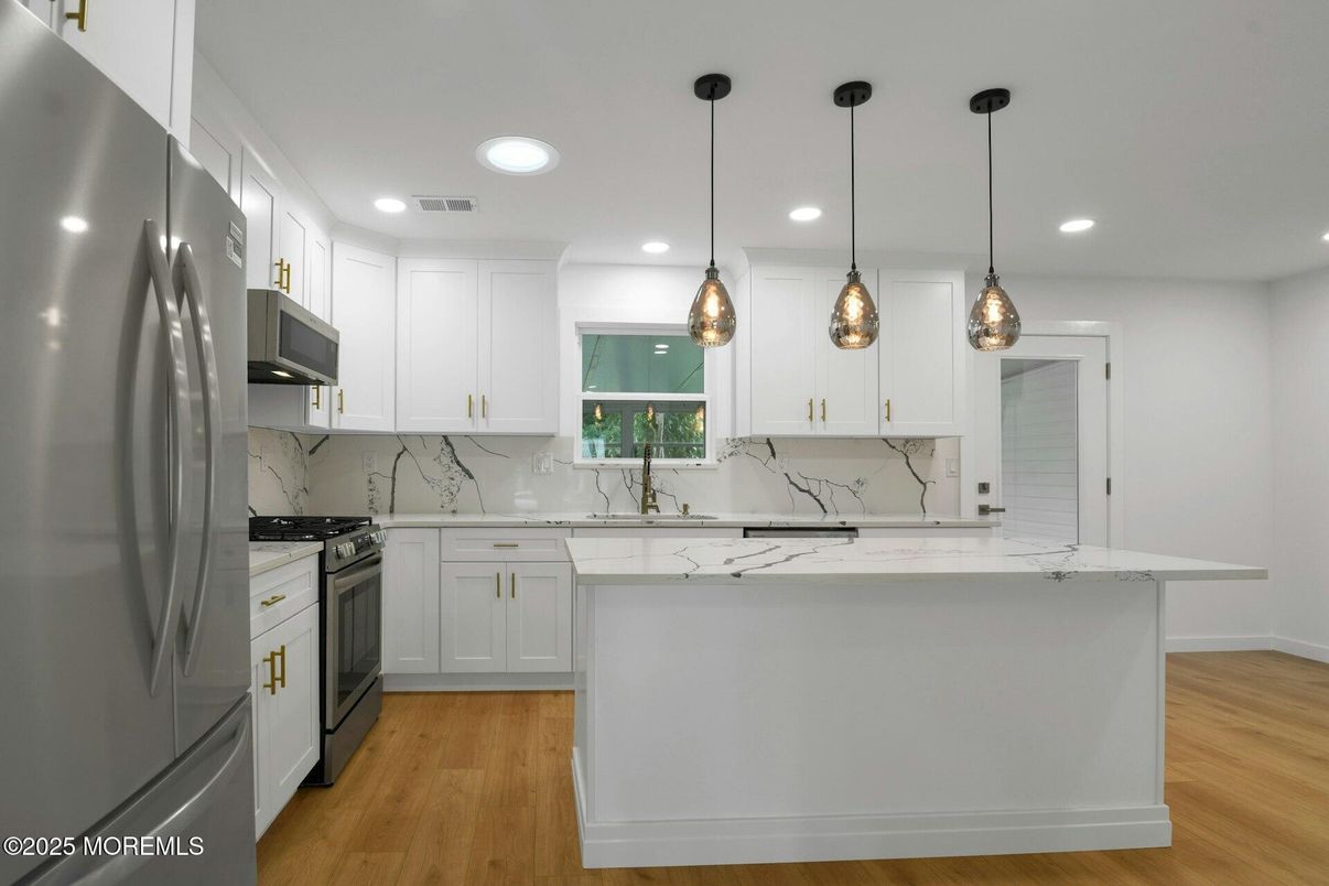 Interior, Kitchen, Marble Walls, Pendant Lights, Recessed Lighting, Stainless Steel Appliances, Wood Texture Flooring