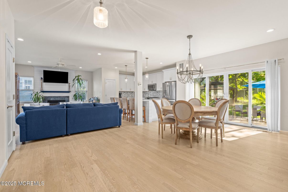 Chandelier, Dining room, Fireplace, Interior, Kitchen, Living room, Pendant Lights, Recessed Lighting, Stainless Steel Appliances, Wood Texture Flooring
