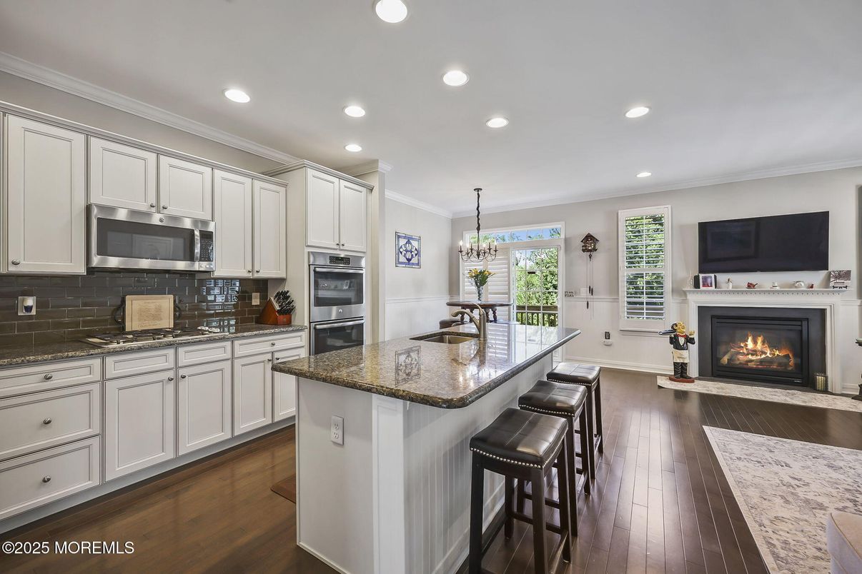 Chandelier, Fireplace, Interior, Kitchen, Pendant Lights, Recessed Lighting, Stainless Steel Appliances, Wood Texture Flooring