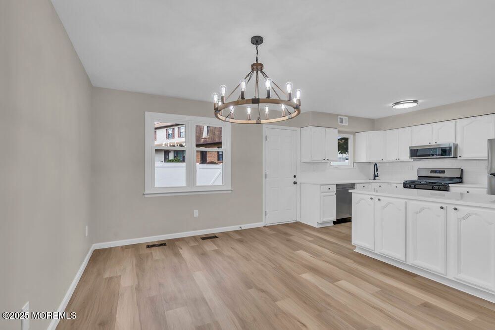 Chandelier, Interior, Kitchen, Pendant Lights, Stainless Steel Appliances, Wood Texture Flooring