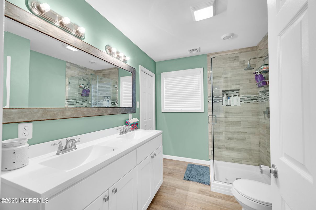 Bathroom, Dual Sink Vanities, Glass Shower, Interior, Recessed Lighting, Wood Texture Flooring