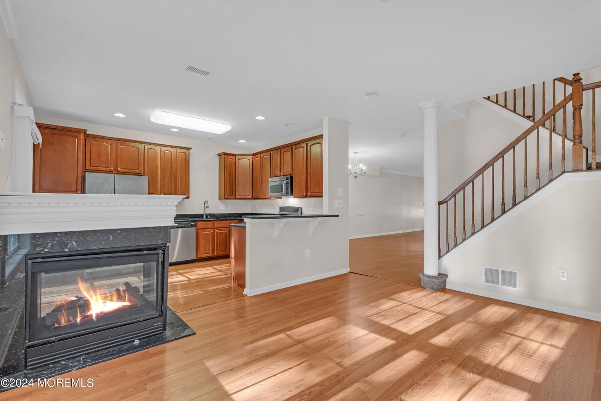 Chandelier, Fireplace, Interior, Kitchen, Recessed Lighting, Wood Texture Flooring