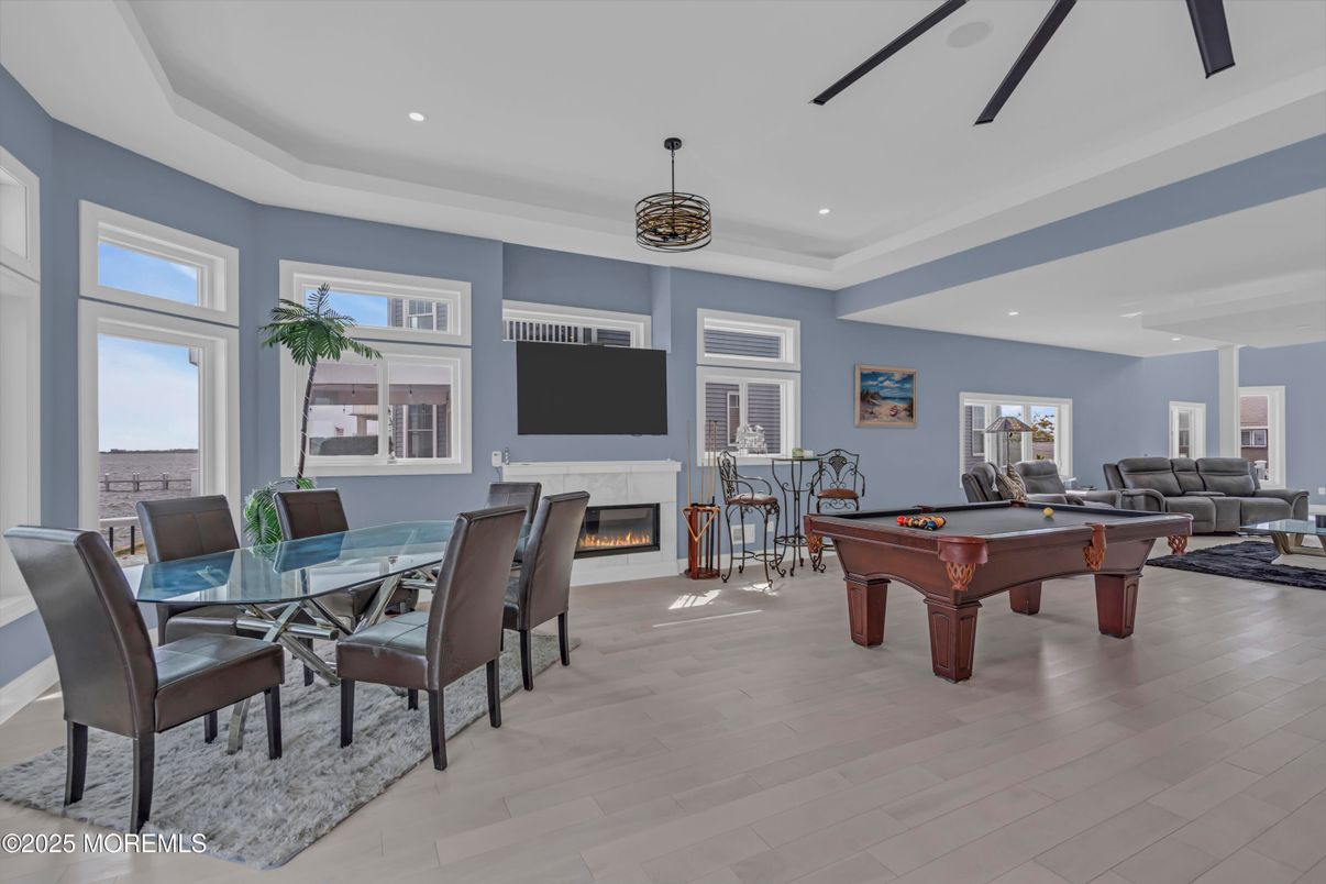 Billiard Table, Dining room, Fireplace, Game Room, Interior, Living room, Pendant Lights, Recessed Lighting, Wood Texture Flooring