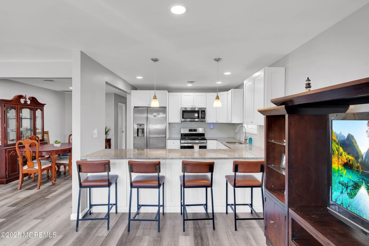 Dining room, Interior, Kitchen, Pendant Lights, Recessed Lighting, Stainless Steel Appliances, Wood Texture Flooring