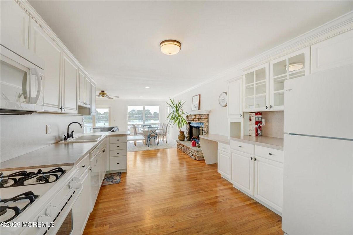 Dining room, Fireplace, Interior, Kitchen, Recessed Lighting, Wood Texture Flooring