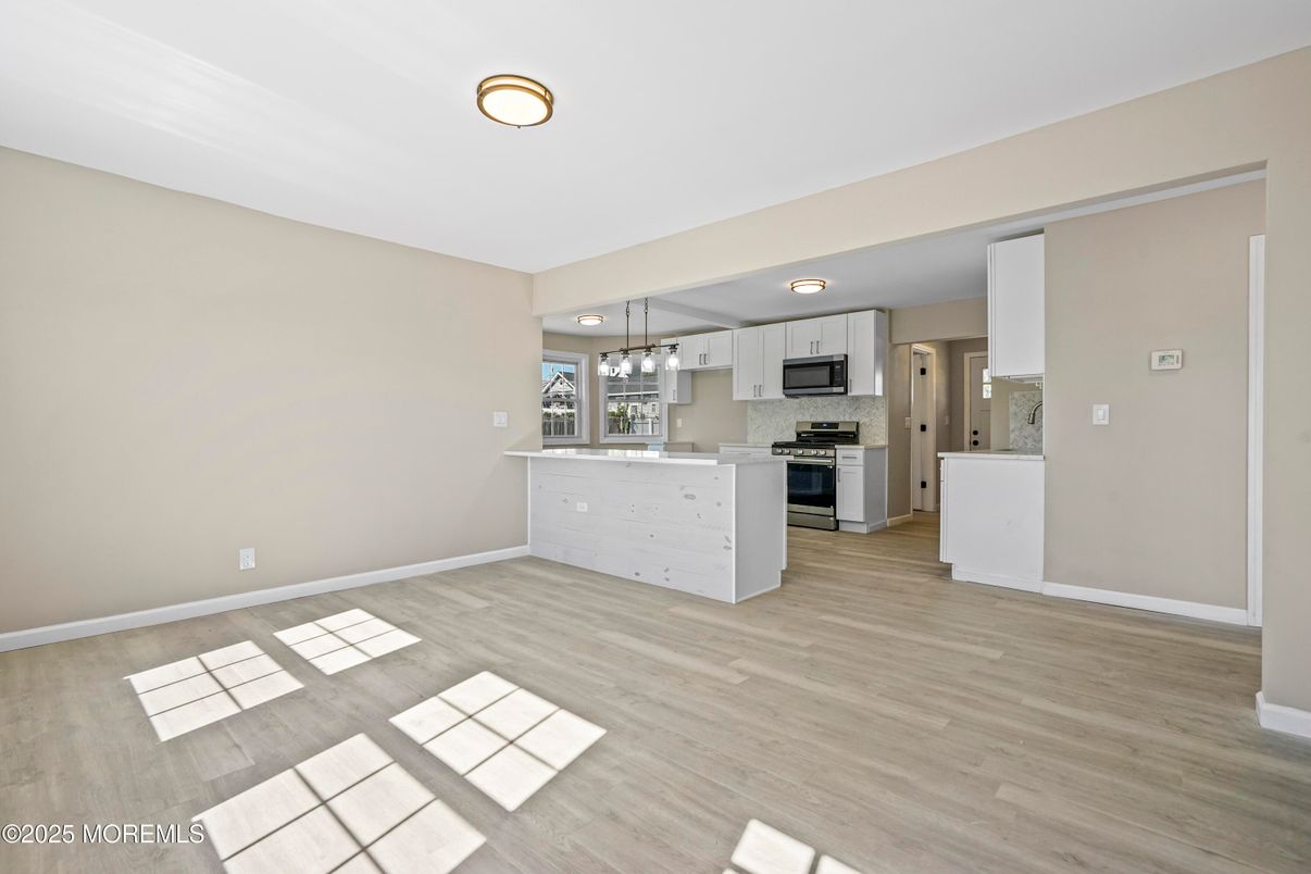 Empty room, Interior, Kitchen, Pendant Lights, Stainless Steel Appliances, Wood Texture Flooring