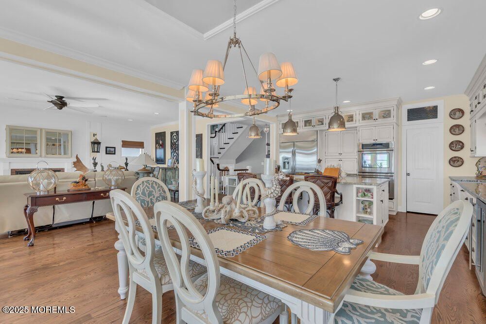 Chandelier, Dining room, Interior, Kitchen, Living room, Pendant Lights, Recessed Lighting, Stainless Steel Appliances, Wood Texture Flooring