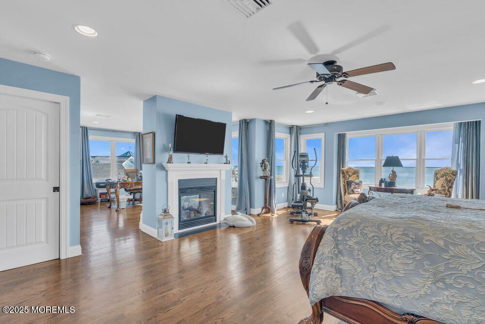 Bedroom, Fireplace, Interior, Recessed Lighting, Water, Wood Texture Flooring