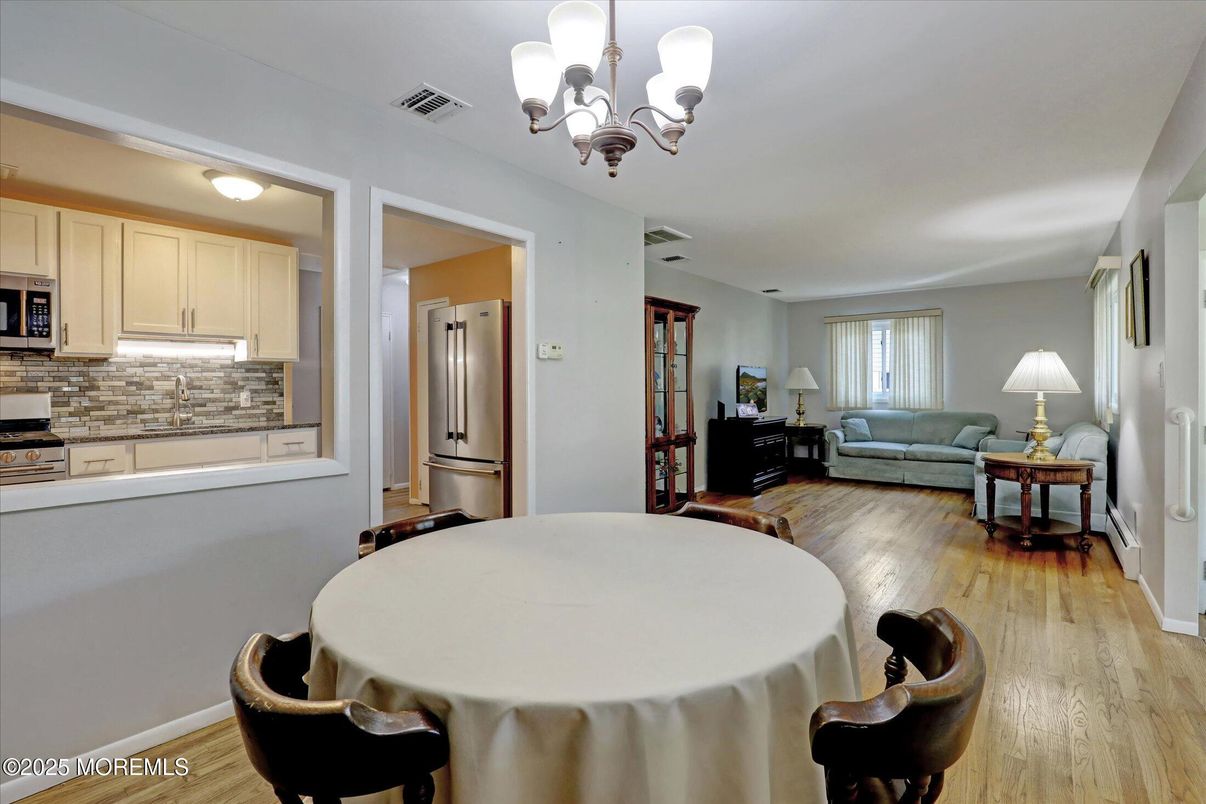 Chandelier, Dining room, Interior, Kitchen, Living room, Stainless Steel Appliances, Wood Texture Flooring