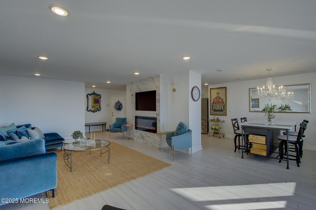 Chandelier, Dining room, Fireplace, Interior, Living room, Marble Walls, Recessed Lighting, Wood Texture Flooring