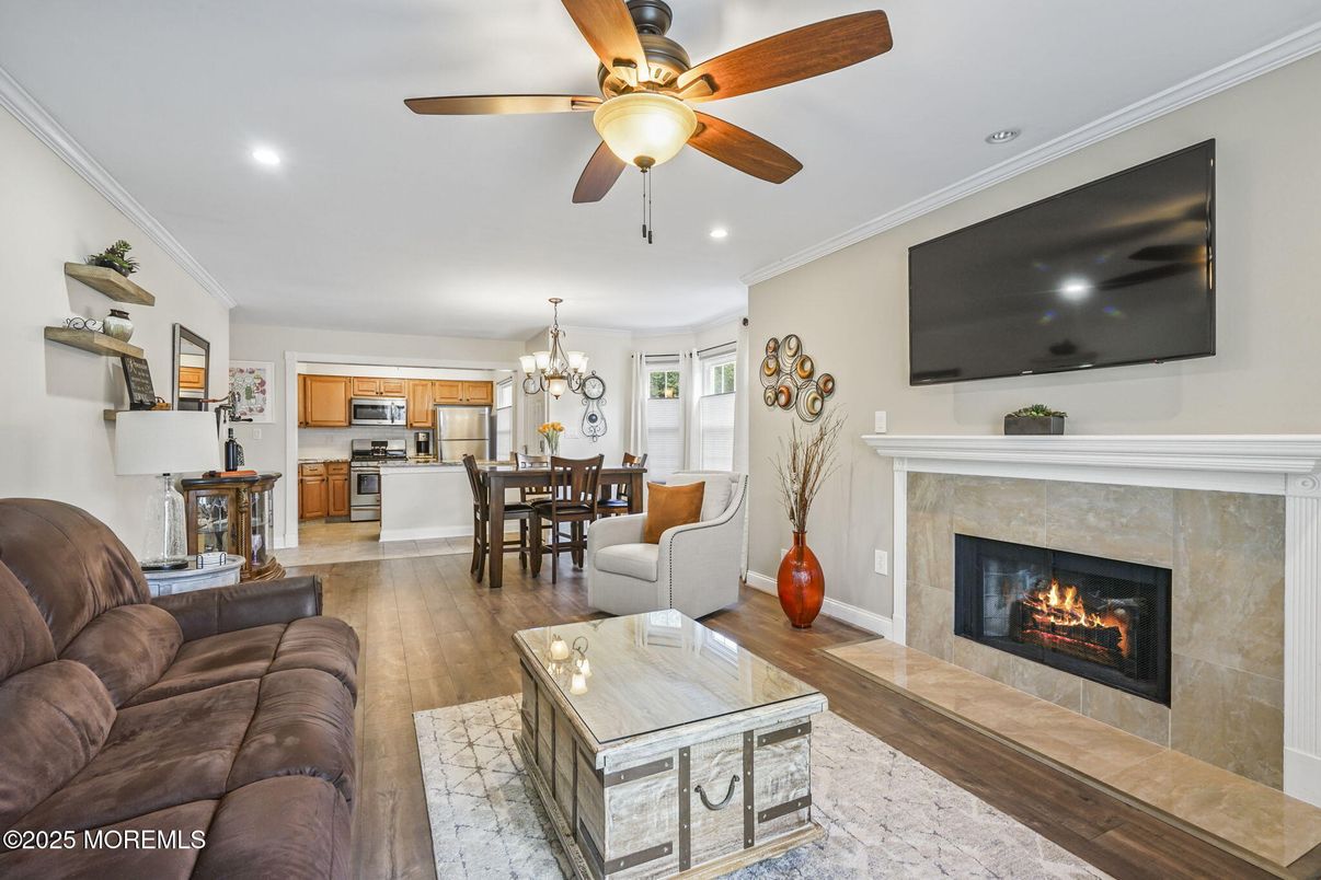 Chandelier, Dining room, Fireplace, Interior, Kitchen, Living room, Recessed Lighting, Stainless Steel Appliances, Wood Texture Flooring