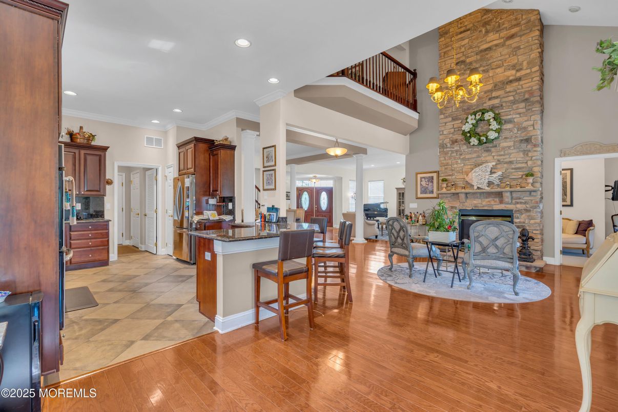 Chandelier, Dining room, Fireplace, Interior, Kitchen, Recessed Lighting, Stone Walls, Wood Texture Flooring
