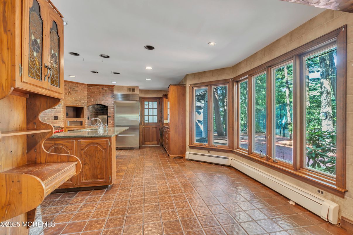 Fireplace, Interior, Kitchen, Recessed Lighting, Stainless Steel Appliances, Stone Walls