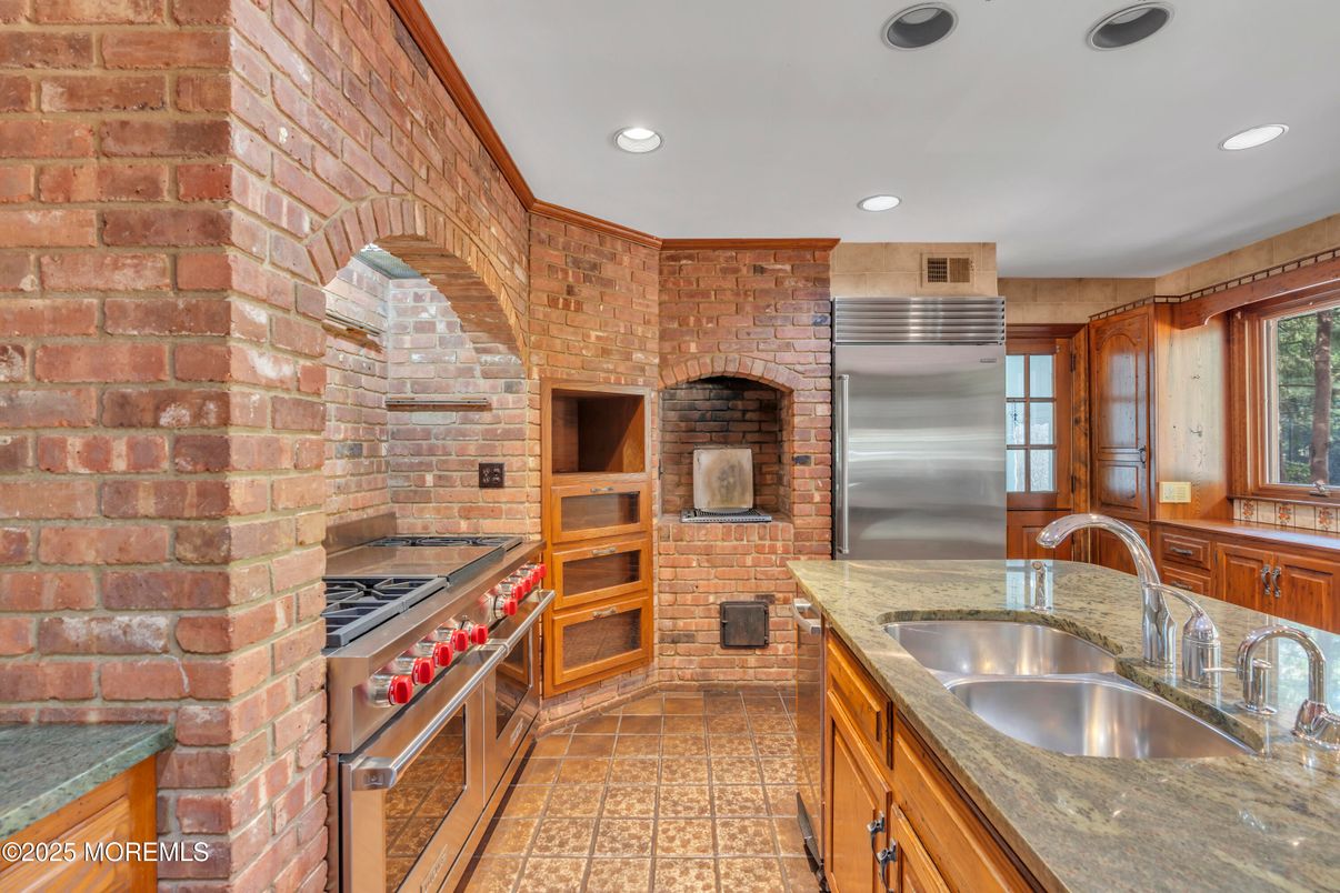 Fireplace, Interior, Kitchen, Recessed Lighting, Stainless Steel Appliances, Stone Walls