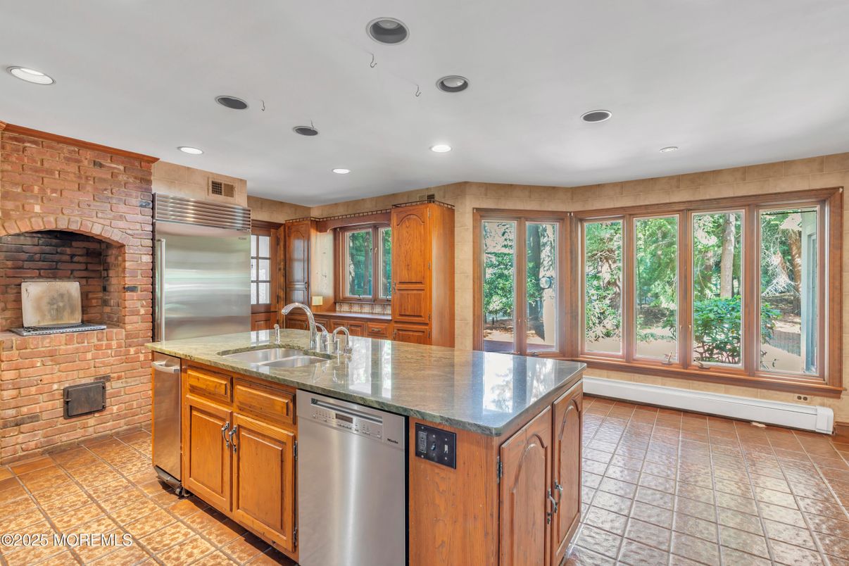 Fireplace, Interior, Kitchen, Recessed Lighting, Stainless Steel Appliances, Stone Walls