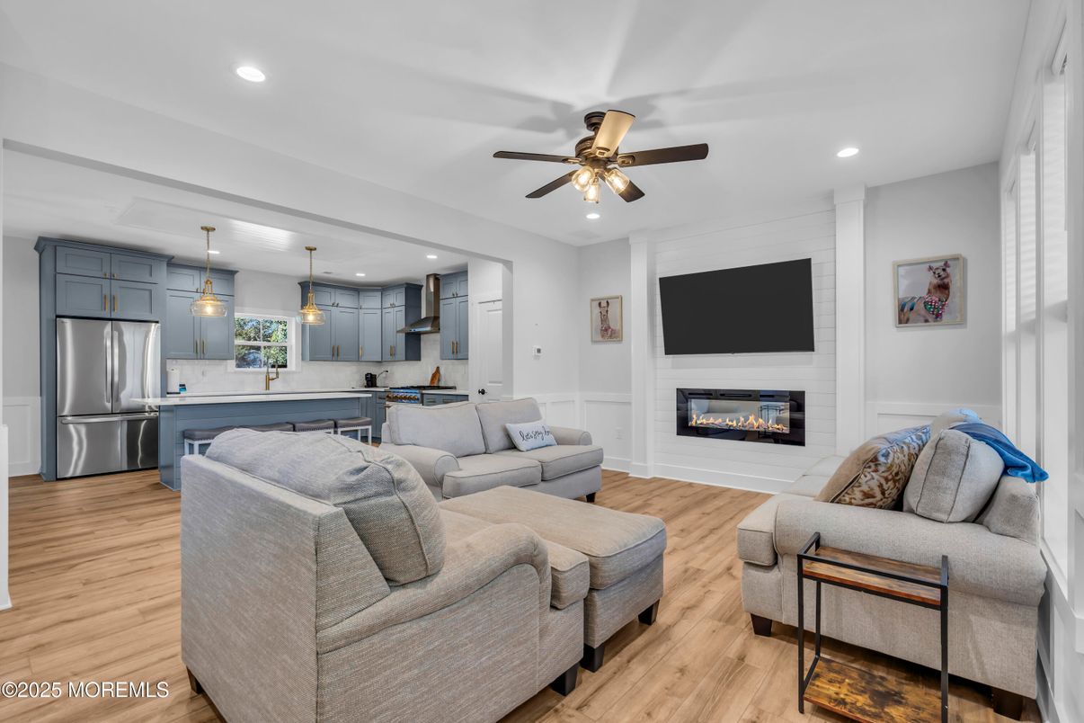 Fireplace, Interior, Kitchen, Living room, Pendant Lights, Recessed Lighting, Stainless Steel Appliances, Wood Texture Flooring