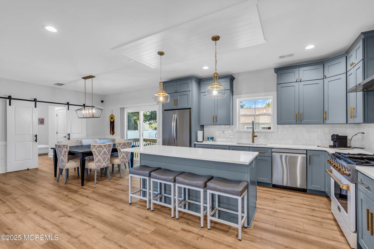 Dining room, Interior, Kitchen, Pendant Lights, Recessed Lighting, Stainless Steel Appliances, Wood Texture Flooring