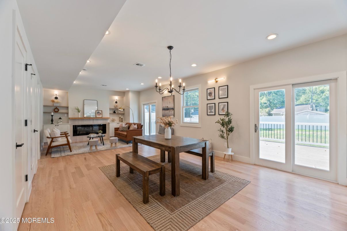 Chandelier, Dining room, Fireplace, Interior, Living room, Pendant Lights, Recessed Lighting, Wood Texture Flooring