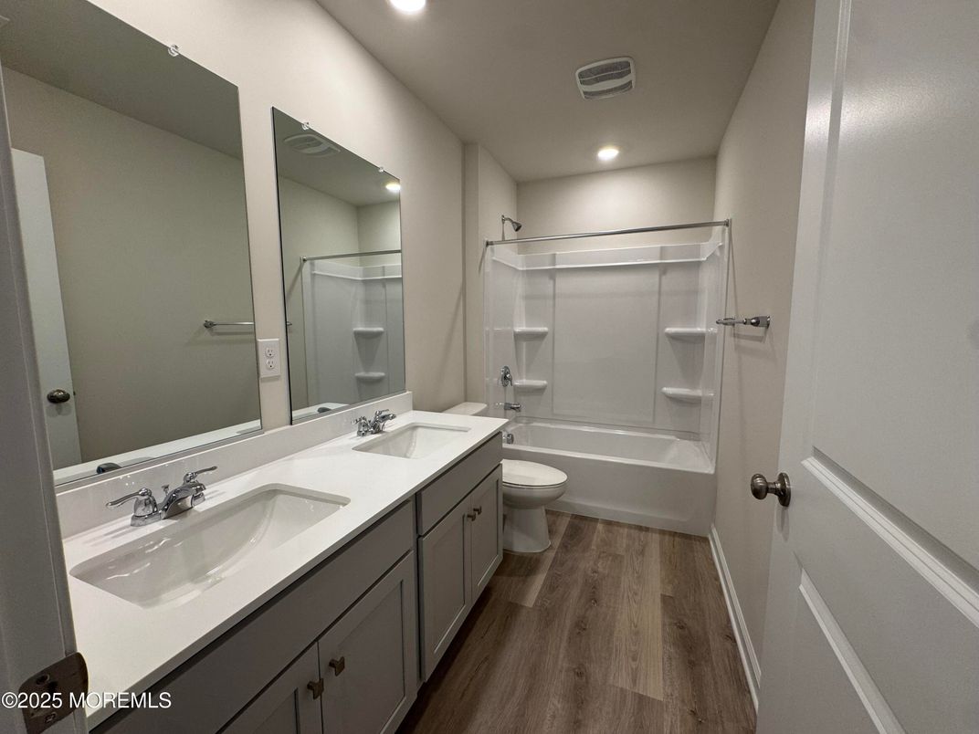 Bathroom, Dual Sink Vanities, Interior, Recessed Lighting, Walk-in Closets, Wood Texture Flooring
