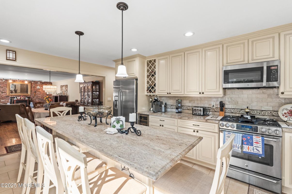 Chandelier, Dining room, Interior, Kitchen, Pendant Lights, Recessed Lighting, Stainless Steel Appliances, Stone Walls