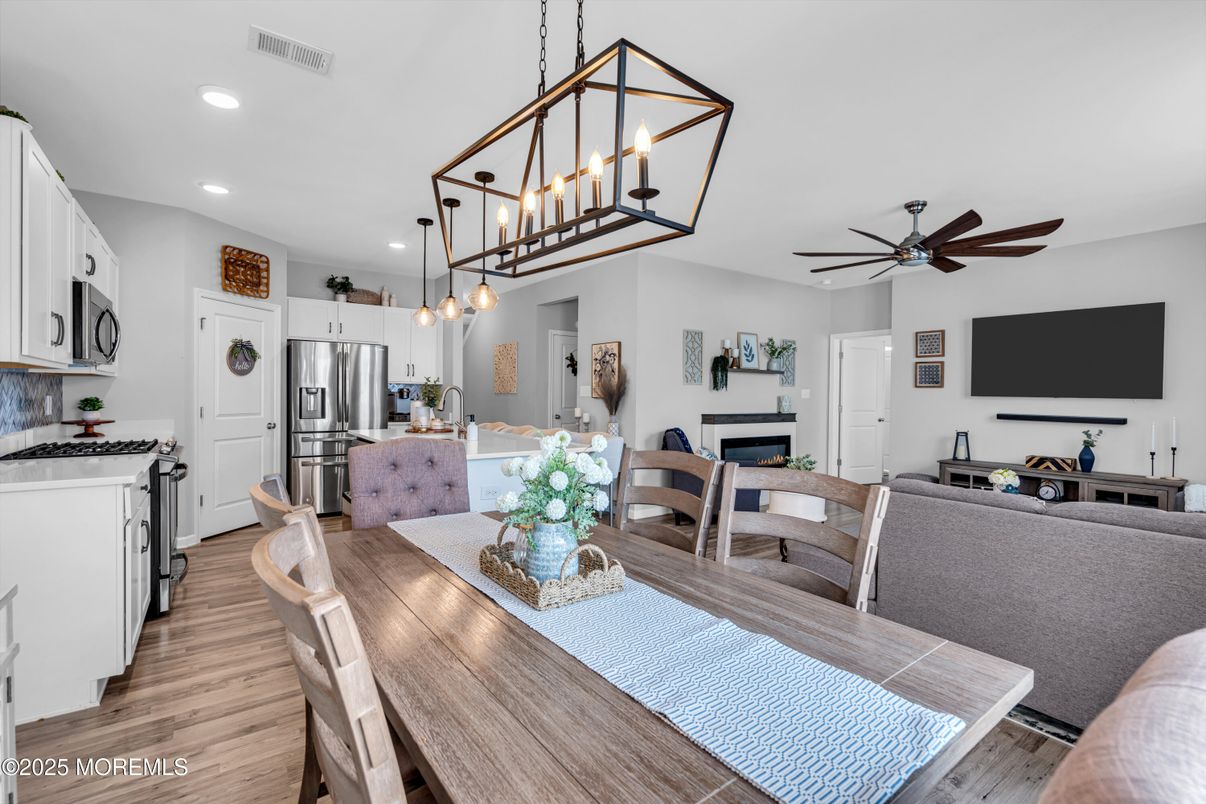 Dining room, Fireplace, Interior, Kitchen, Pendant Lights, Recessed Lighting, Stainless Steel Appliances, Wood Texture Flooring