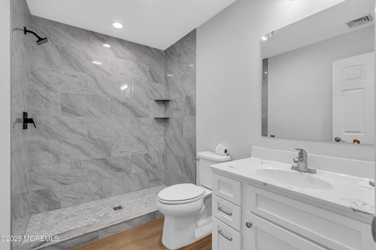 Bathroom, Glass Shower, Interior, Marble Walls, Recessed Lighting, Wood Texture Flooring