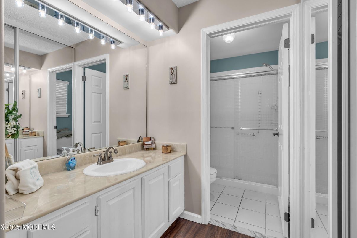 Bathroom, Dual Sink Vanities, Glass Shower, Interior, Tile Countertops, Wood Texture Flooring