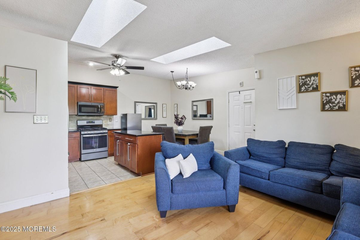 Chandelier, Dining room, Interior, Kitchen, Living room, Stainless Steel Appliances, Wood Texture Flooring