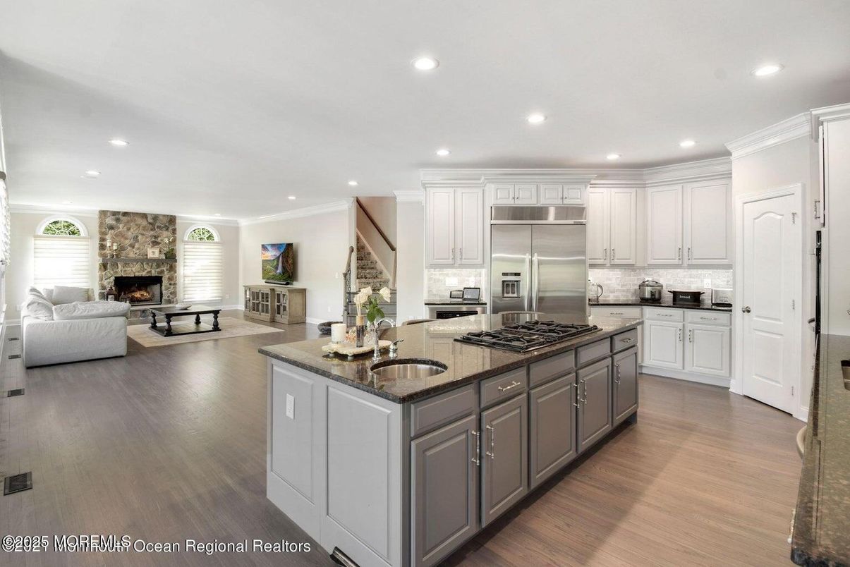 Fireplace, Interior, Kitchen, Living room, Recessed Lighting, Stainless Steel Appliances, Wood Texture Flooring
