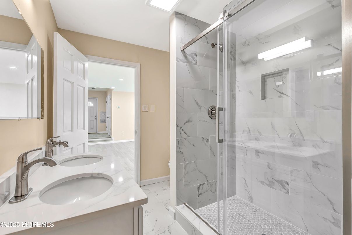 Bathroom, Dual Sink Vanities, Glass Shower, Interior, Marble, Marble Walls, Recessed Lighting