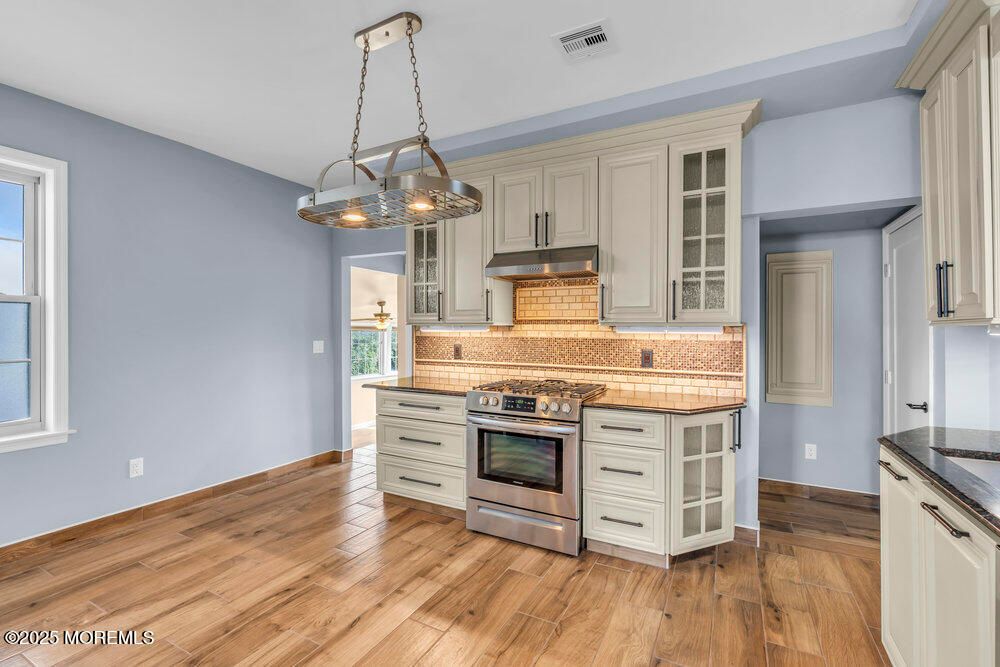 Interior, Kitchen, Pendant Lights, Stainless Steel Appliances, Tile Countertops, Wood Texture Flooring