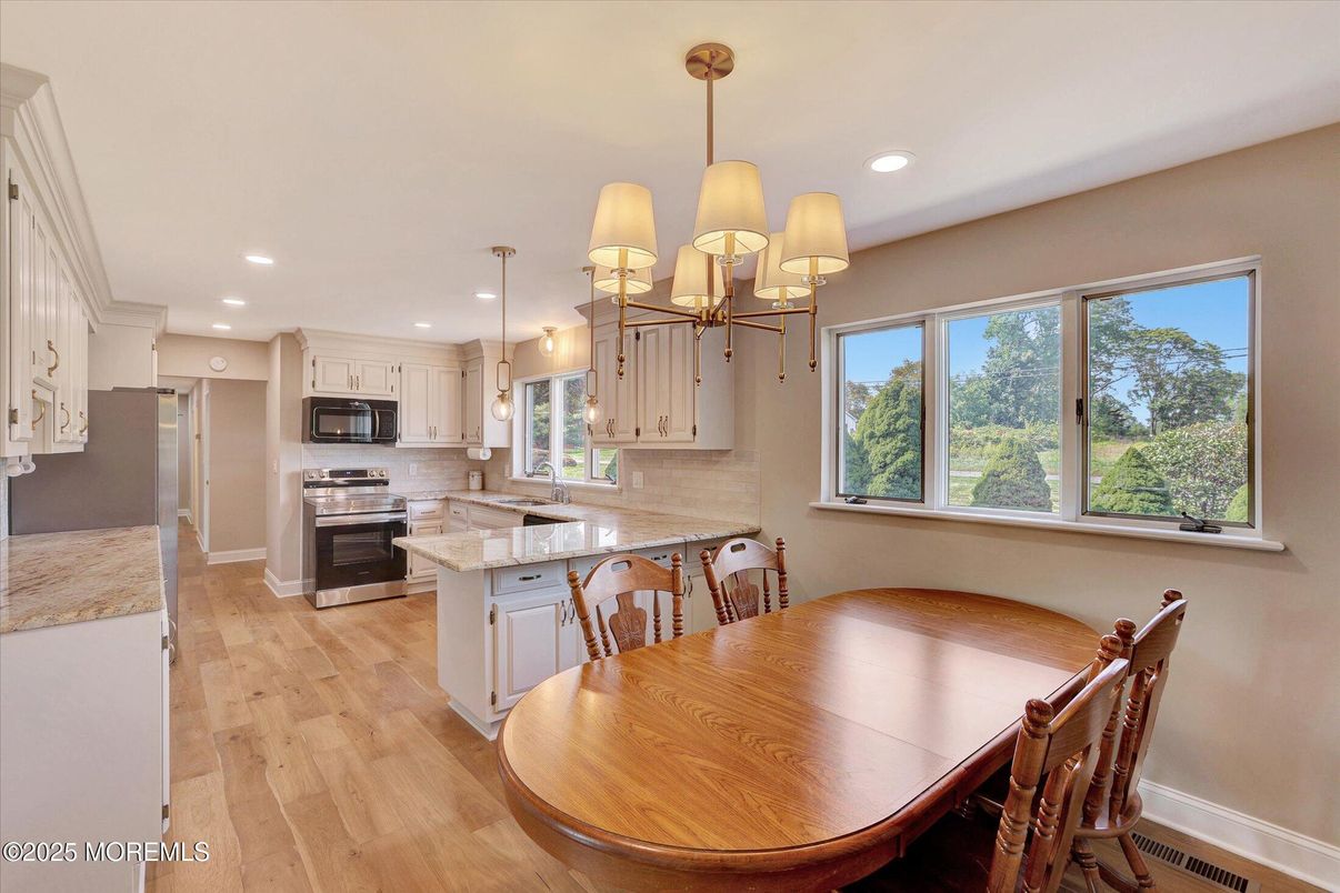 Chandelier, Dining room, Interior, Kitchen, Pendant Lights, Recessed Lighting, Stainless Steel Appliances, Wood Texture Flooring