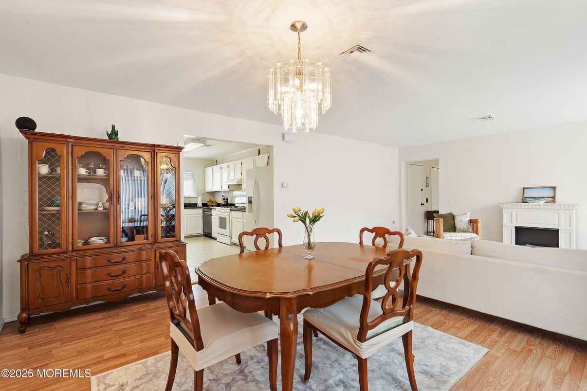 Chandelier, Dining room, Fireplace, Interior, Kitchen, Living room, Stainless Steel Appliances, Wood Texture Flooring