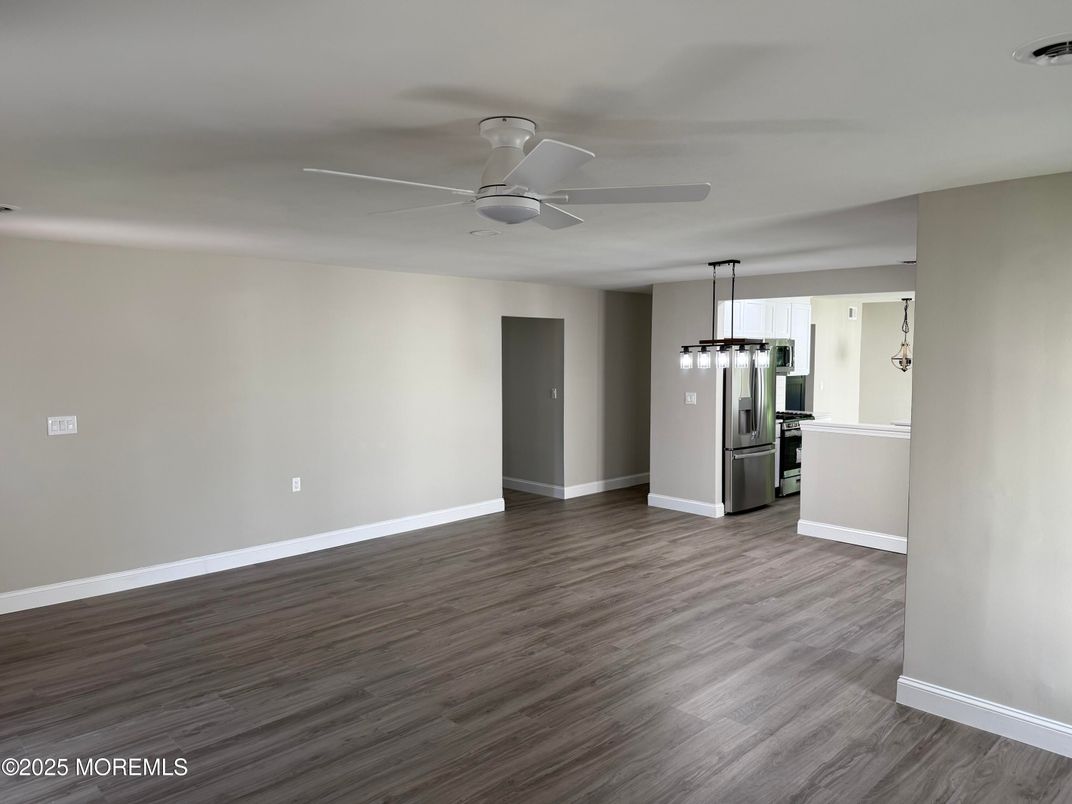 Empty room, Interior, Kitchen, Pendant Lights, Stainless Steel Appliances, Wood Texture Flooring