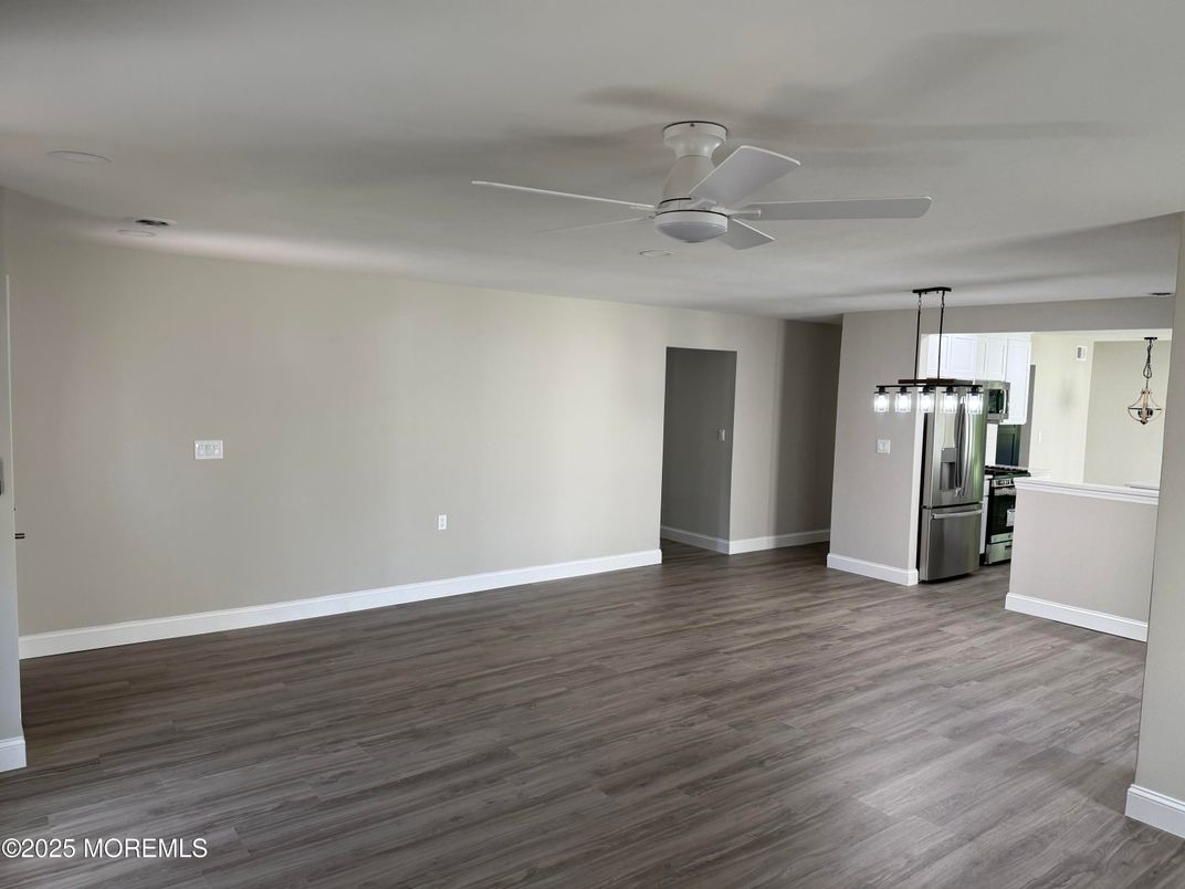 Empty room, Interior, Kitchen, Pendant Lights, Stainless Steel Appliances, Wood Texture Flooring
