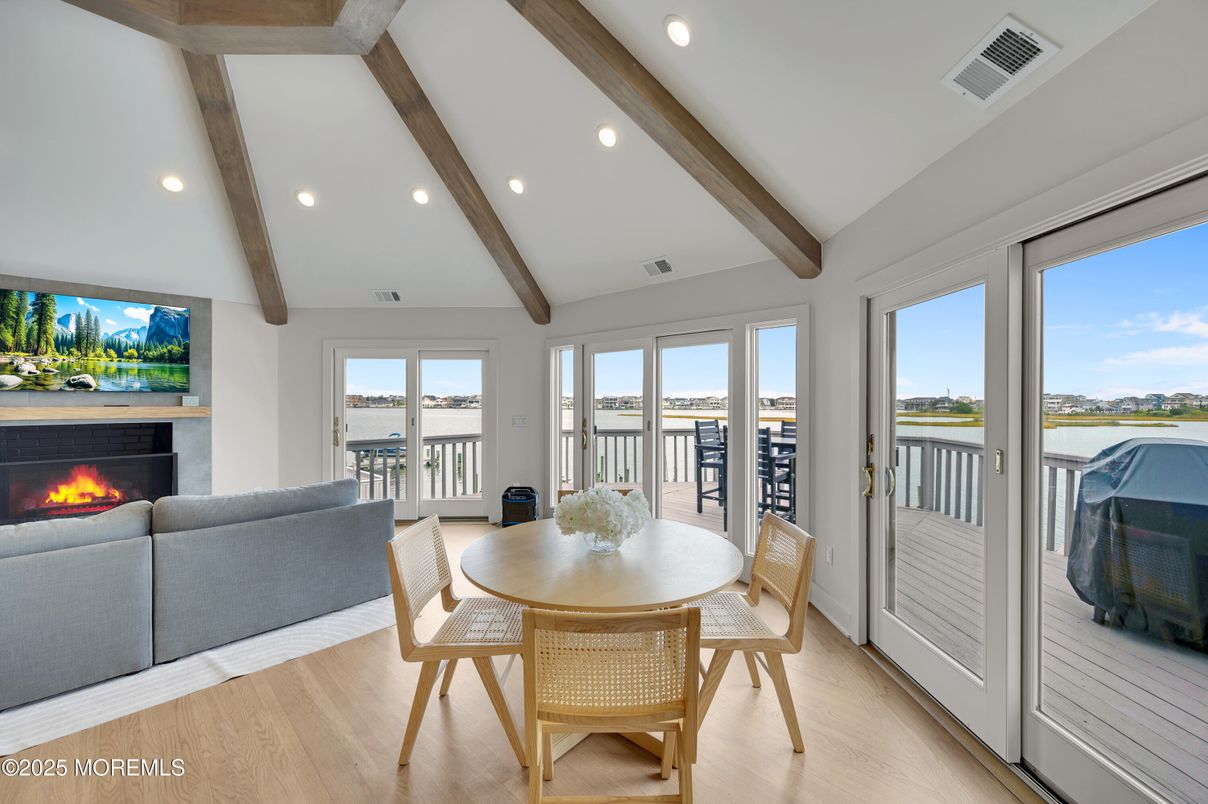 Dining room, Fireplace, Interior, Living room, Recessed Lighting, Water, Wooden Beams, Wood Texture Flooring