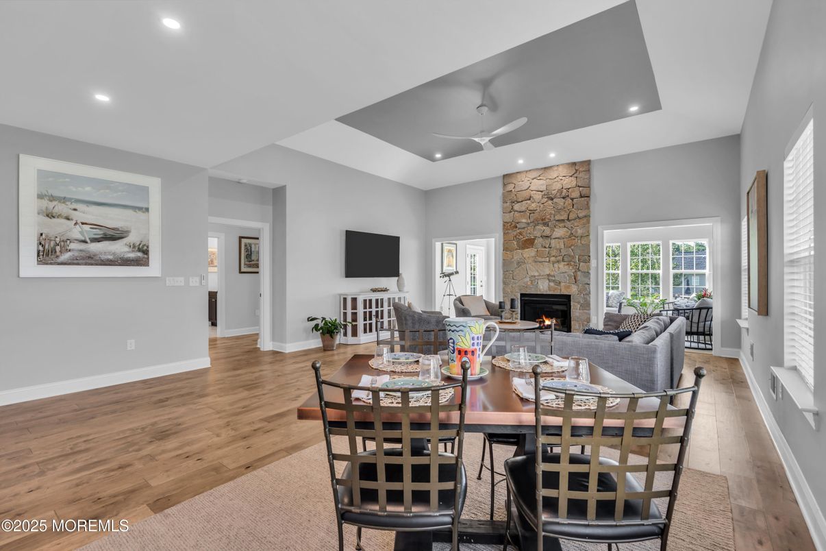 Dining room, Fireplace, Interior, Living room, Recessed Lighting, Stone Walls, Wood Texture Flooring