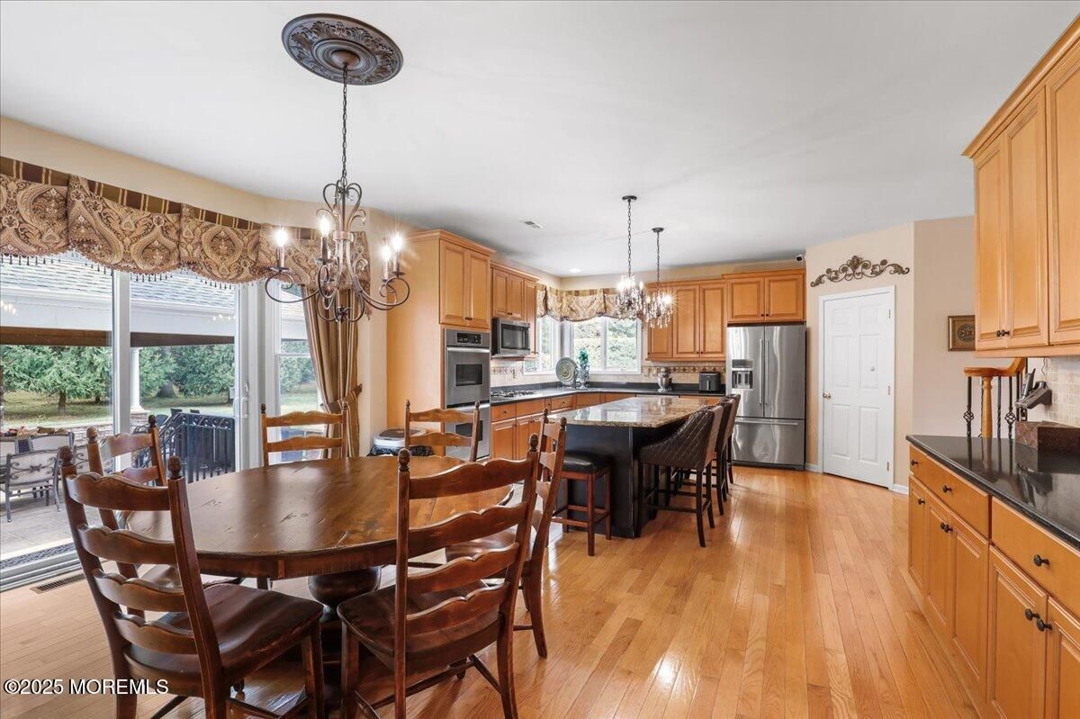 Chandelier, Dining room, Interior, Kitchen, Pendant Lights, Stainless Steel Appliances, Wood Texture Flooring