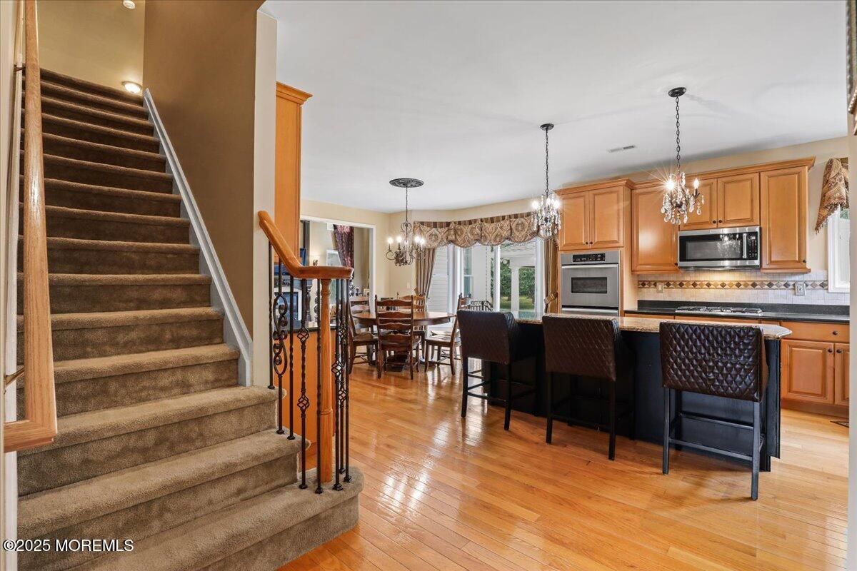 Chandelier, Dining room, Interior, Kitchen, Pendant Lights, Recessed Lighting, Stainless Steel Appliances, Wood Texture Flooring