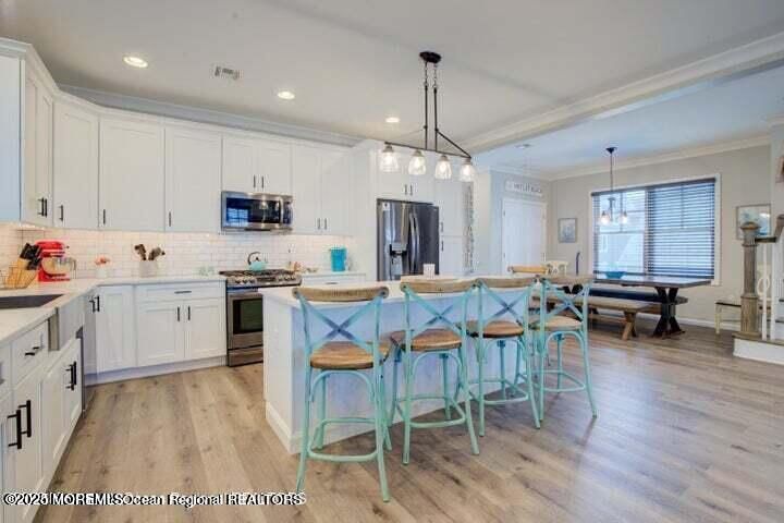 Dining room, Interior, Kitchen, Pendant Lights, Recessed Lighting, Stainless Steel Appliances, Wood Texture Flooring