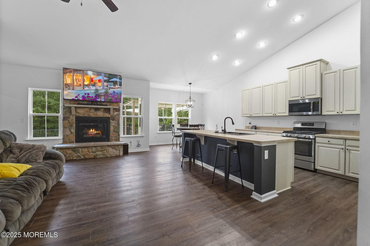Fireplace, Interior, Kitchen, Living room, Pendant Lights, Recessed Lighting, Stainless Steel Appliances, Wood Texture Flooring