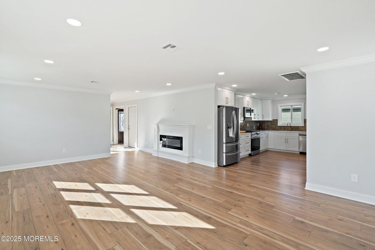 Empty room, Interior, Kitchen, Recessed Lighting, Stainless Steel Appliances, Wood Texture Flooring
