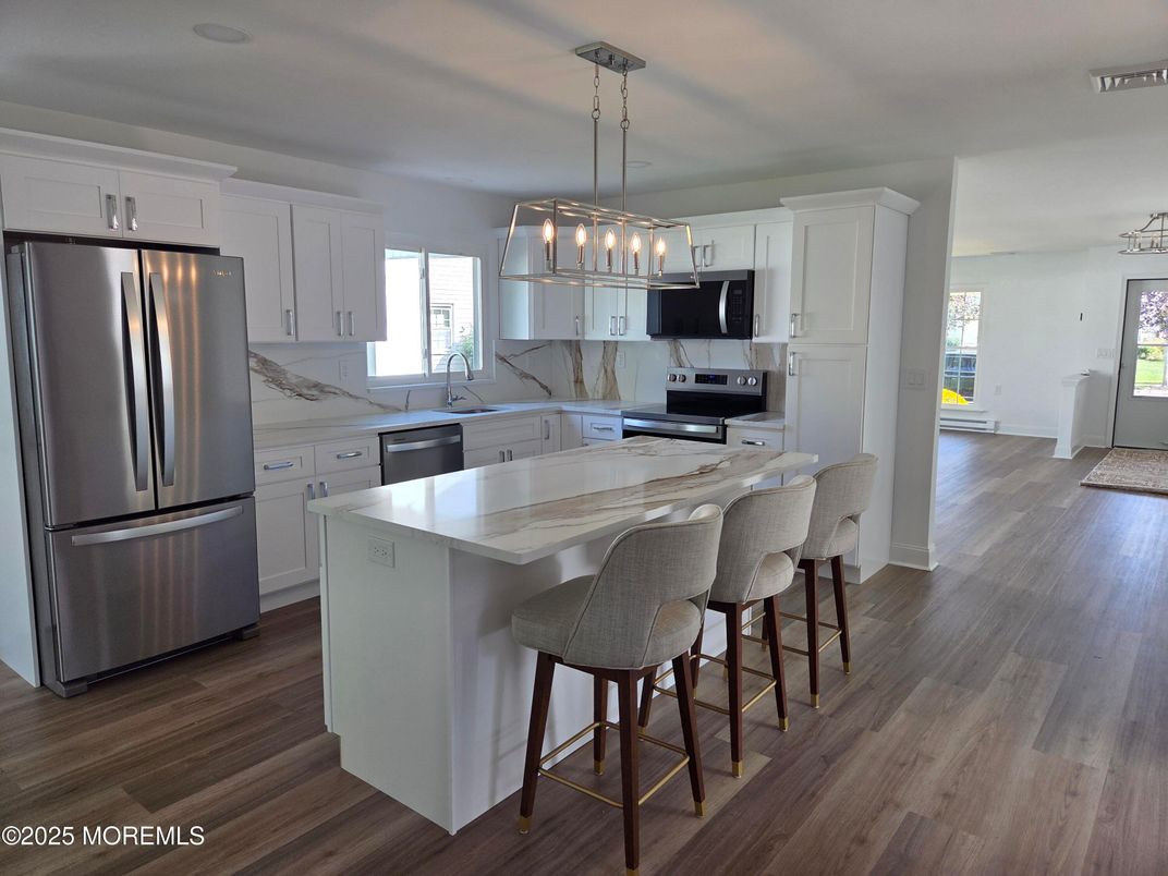 Interior, Kitchen, Marble Walls, Pendant Lights, Stainless Steel Appliances, Wood Texture Flooring