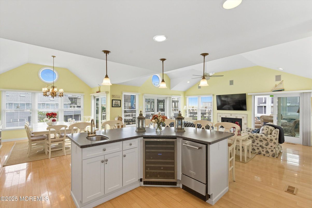 Chandelier, Dining room, Fireplace, Interior, Living room, Pendant Lights, Recessed Lighting, Wood Texture Flooring